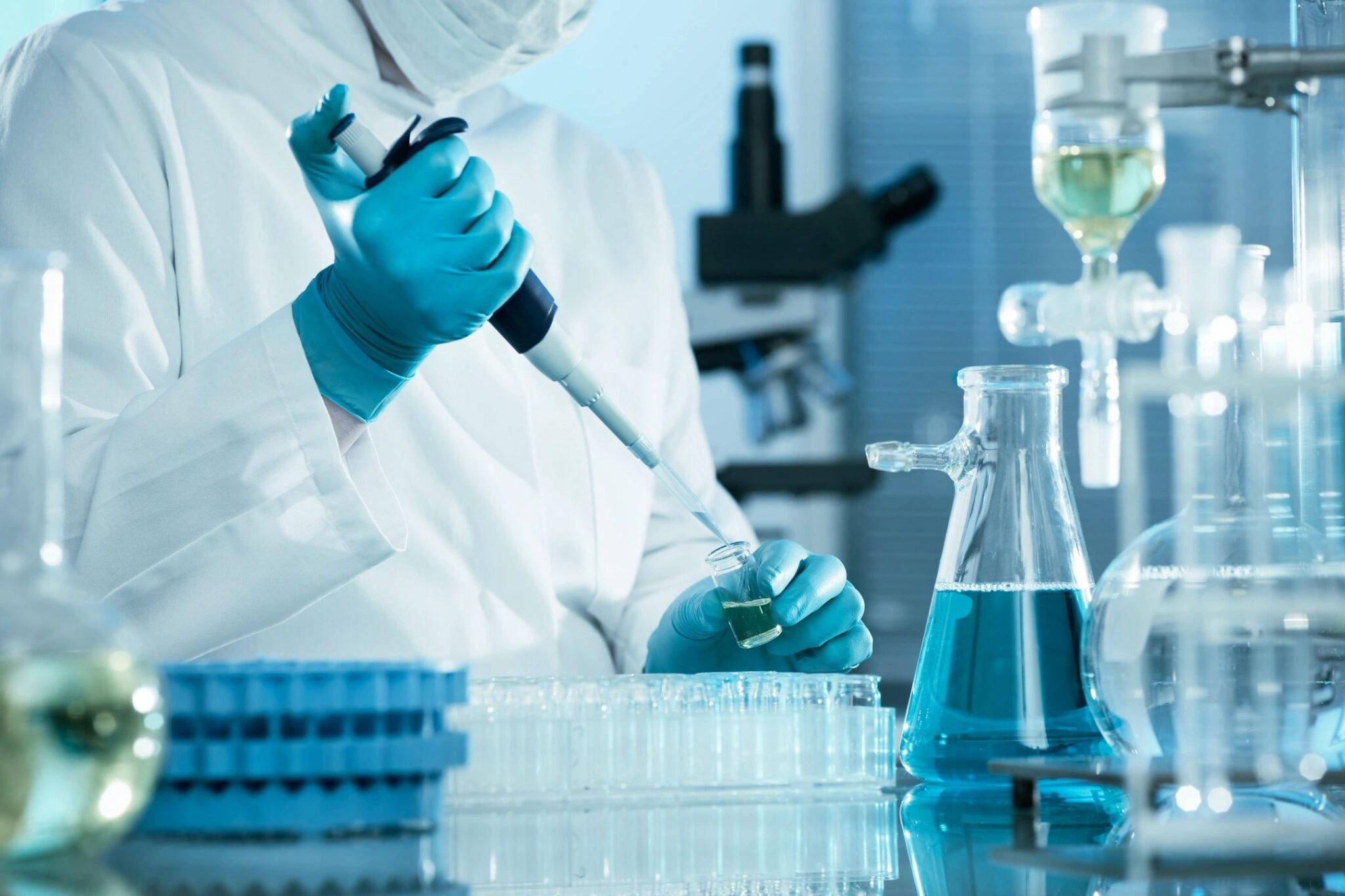 Scientist in lab coat conducting research with microscope
