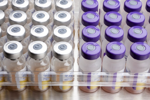 Medicine vials in a glass tube with purple and white cap